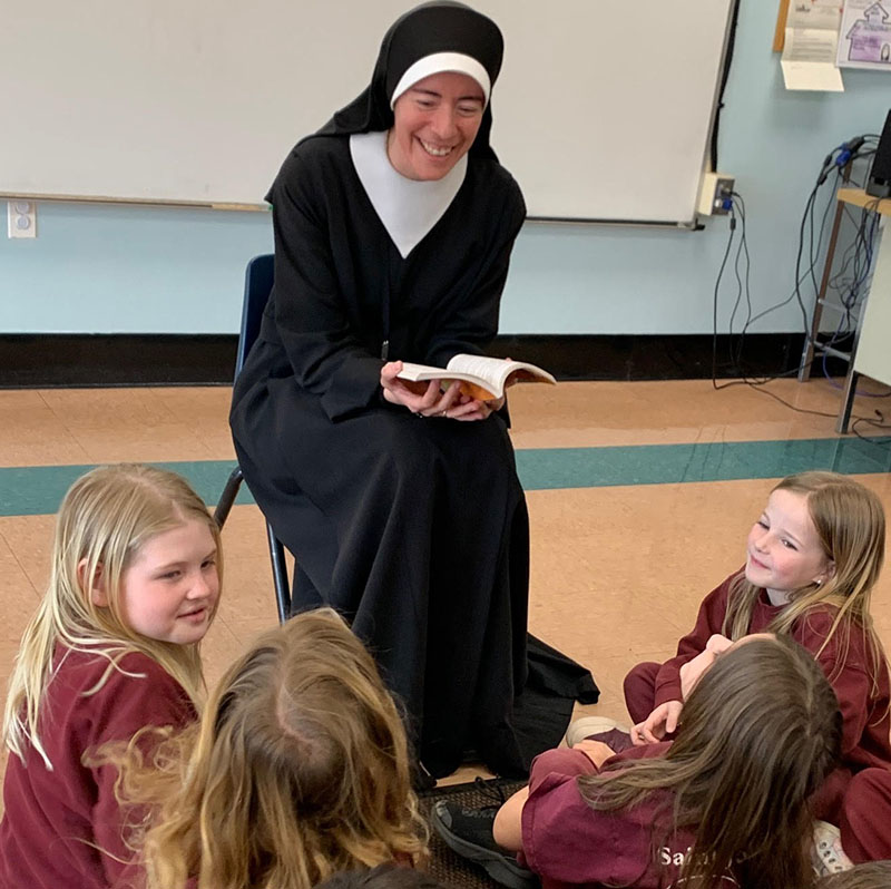 Sister Gabriela enjoys reading stories about Our Blessed Mother to her Second Grade students.