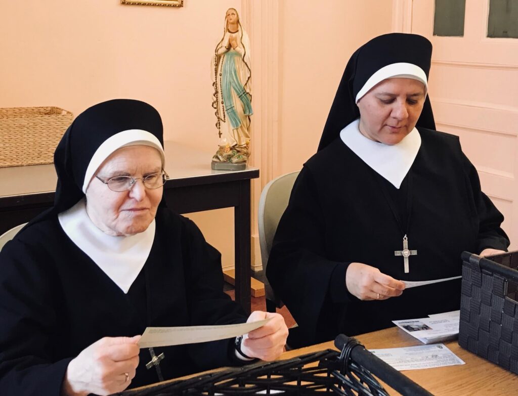 Sr. Elizabeth and Lucette reading prayer cards