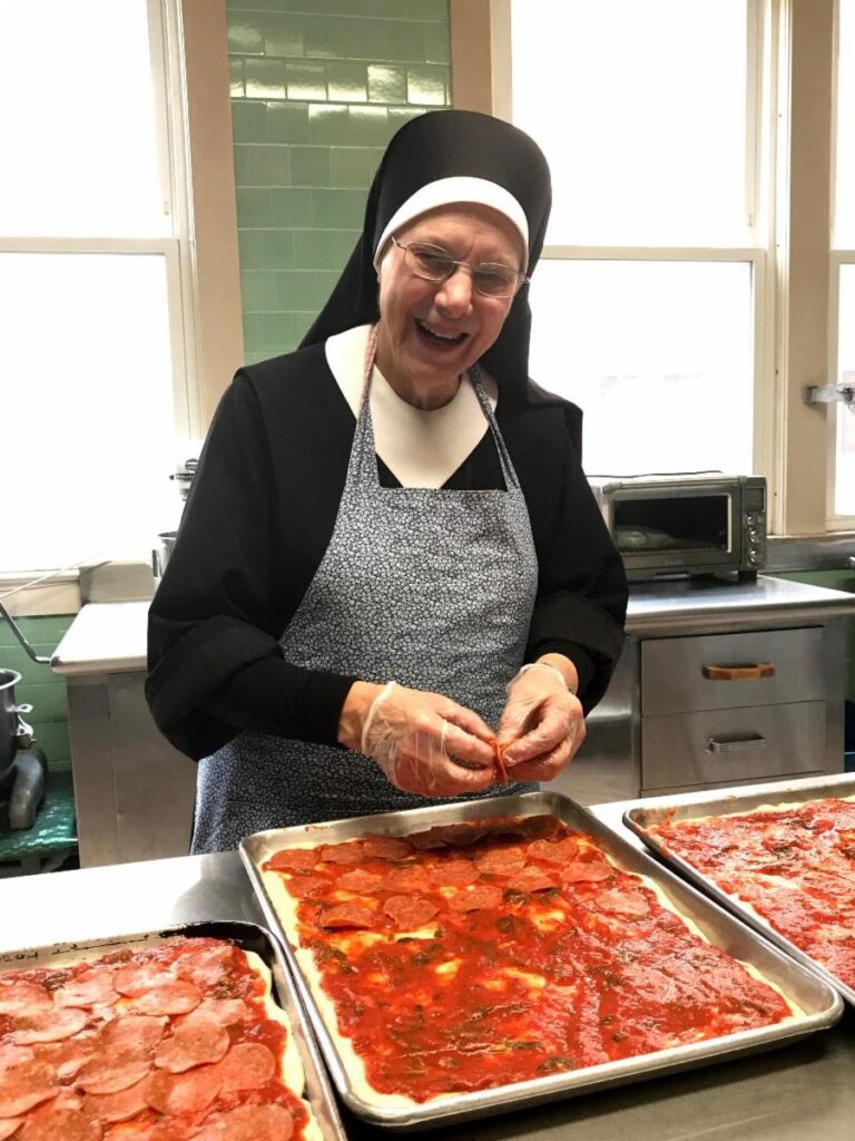 Sister Mark making pizza